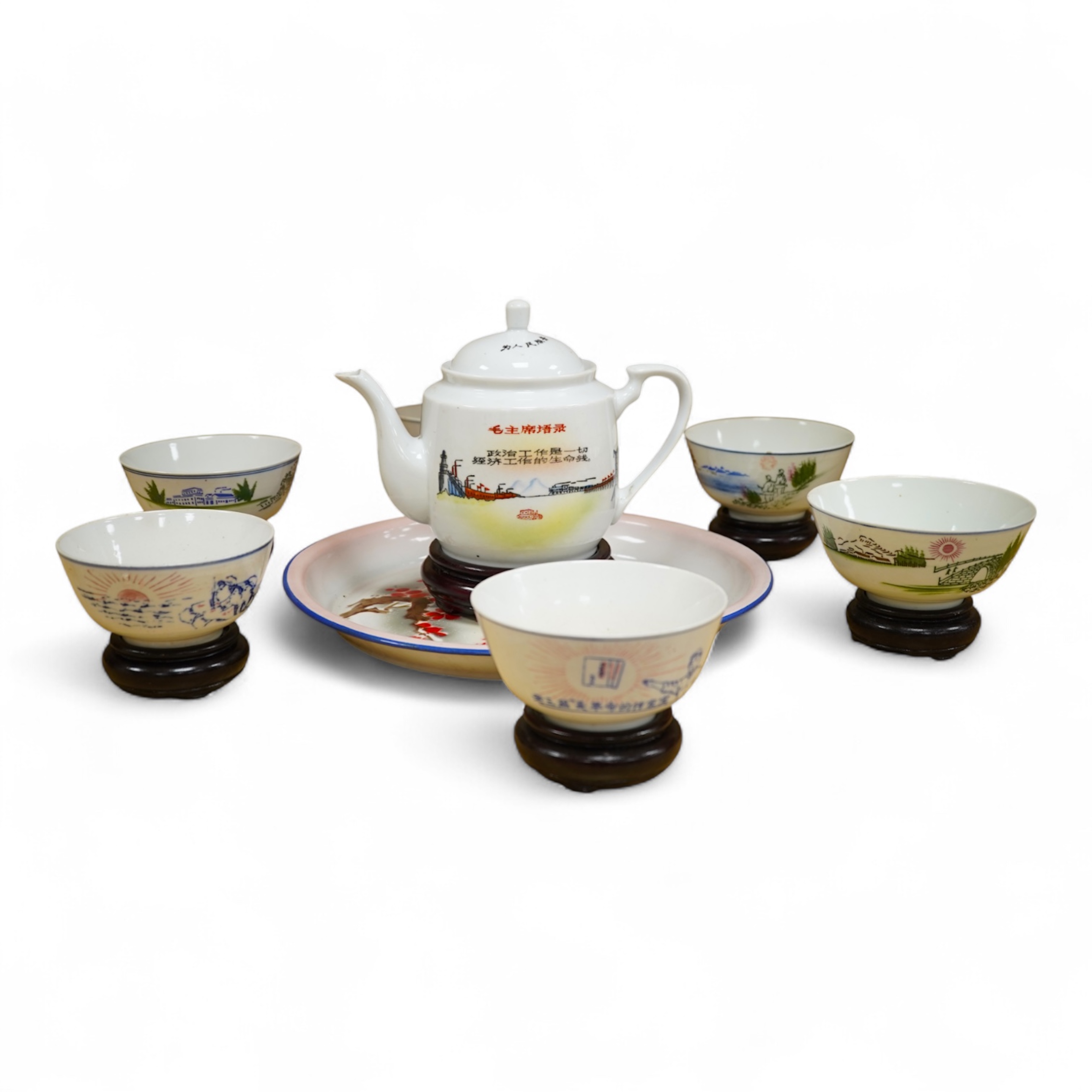 A Chinese Cultural Revolution porcelain teapot, six bowls, wood stands and an enamel tray-29.5cm diameter. (8)